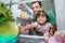 Young father and daughter open refrigerator at home looking for some food