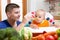 Young father feeding his baby at kitchen