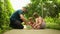 Young father fixing a skateboard for his young daughter