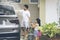 Young father and his kids washing a car