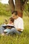 Young father with his little daughter reads the Bible