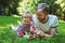 Young father and his son eating strawberries in Park. Picnic. Outdoor portrait