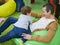 Young father with his son in the playroom. Happy young father plays with his cute little smiling son in a playroom on balloons and