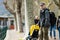 Young father with his toddler son in a stroller having fun in marina of Lecco town. Picturesque waterfront of Lecco located on the