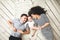 Young father, mother and cute baby lying on floor