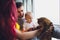 Young father and mother playing with son and cats.