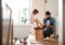 Young father painting small daughter`s nails in a bathroom at home.