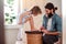 Young father painting small daugter`s nails in a bathroom at home.