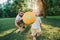 Young father playing ball with toddler baby boy outdoors. Parent spending time together with child son in park. Authentic