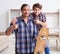 Young father repairing skateboard with his son at home