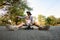 Young father resting sitting on skateboard with his daughter