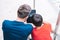 Young father and son sit on steps and play with tablet.The concept of modern technologies