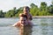 Young father and son swimming in river