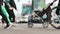 A young father with a stroller crosses the street. Crosswalk. City life. Anonymous people on the background of riding