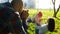 Young father taking pictures of mother and daughter playing in the park at sunset. Happy family photographed in nature