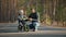 Young father teaches little son to ride a balance bike