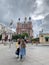 A young father walks with his daughter around the city. A man holds a child by the hand.