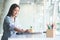 A young female administrative assistant making notes of working planning organizing information in her office