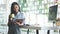 A young female administrative assistant making notes of working planning organizing information in her office