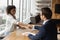 Young female african american job seeker shaking hands with employer.