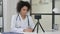 Young Female African Doctor Recording Video on Smartphone