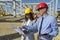 Young Female Architect and Businessman With Digital Tablet Meeting at Construction Site