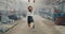 Young female athlete is doing aerial gymnastics in a massive factory building 4k