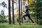 Young female athlete jogging in forest. Jogger doing morning physical training.