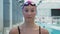 Young female athlete swimmer looks at the camera