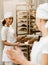 young female bakers working together at baking manufacture