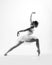 Young female ballet dancer on grey