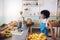 Young female bartender standing at juice bar counter