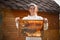 Young female beekeeper hold wooden frame with honeycomb. Collect honey. Beekeeping concept