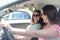 Young female best friends having fun at car roadtrip moment transportation concept and urban ordinary life with women girlfriends