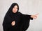 Young female in black hijab pointing at you - Portrait of young woman pointing her finger