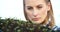 Young Female Botanist Examining Potted Plant