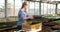 Young Female Botanist Examining Potted Plant