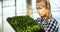 Young Female Botanist Examining Potted Plant