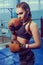 Young female boxer ready to fight in old leather boxing gloves. fitness happy blonde girl in sport wear with perfect body