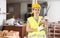 Young female builder standing at construction site with chipping chisel