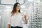 Young female buyer holds many glasses in hand