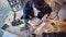 Young Female Carpenter Drawing And Measuring Woodwork Design In Garage Workshop