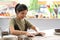 Young female ceramicist creating handicraft crockery in ceramics studio. Activity, handicraft, hobbies concept