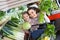 Young female and cheerful smiling little girl shopping green veg