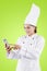 Young female chef using a phone on studio