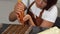 Young female chocolatier adding filling into chocolate molds