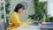 Young female college student sitting at desk at home using laptop