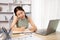 Young female college students talk on the phone and do homework at the same time