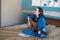Young female composer composes a song on acoustic guitar on bed in bedroom