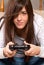 Young female concentrating playing video-games